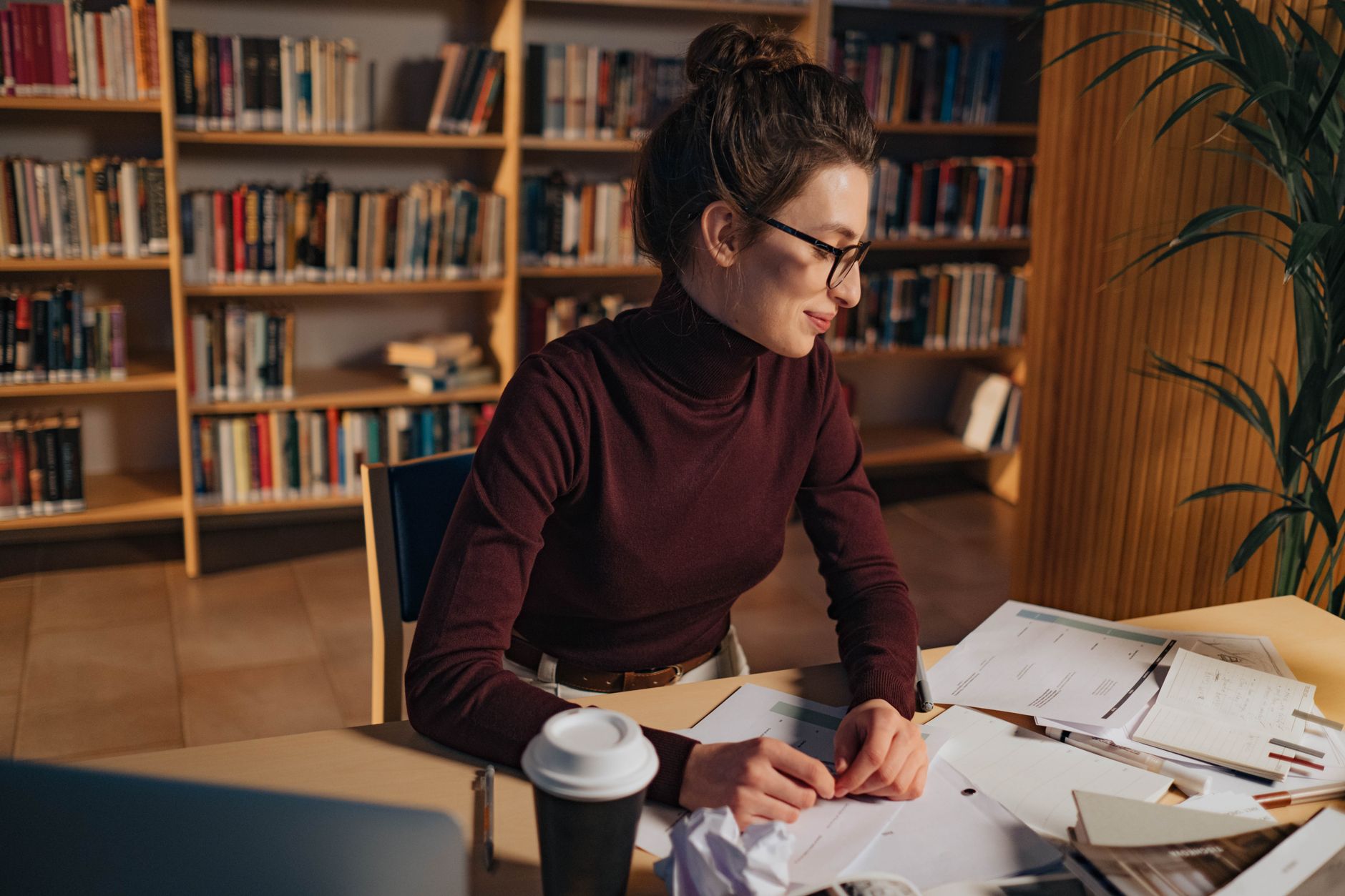 Academic Research, Research Assistant, For Literature Review, Paper Writing Hel — A woman in a library studying papers with determination, 