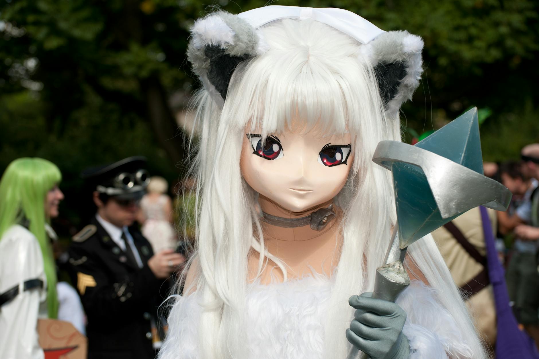 Anime Character — A striking cosplay character with unique costume at an outdoor convention setting.