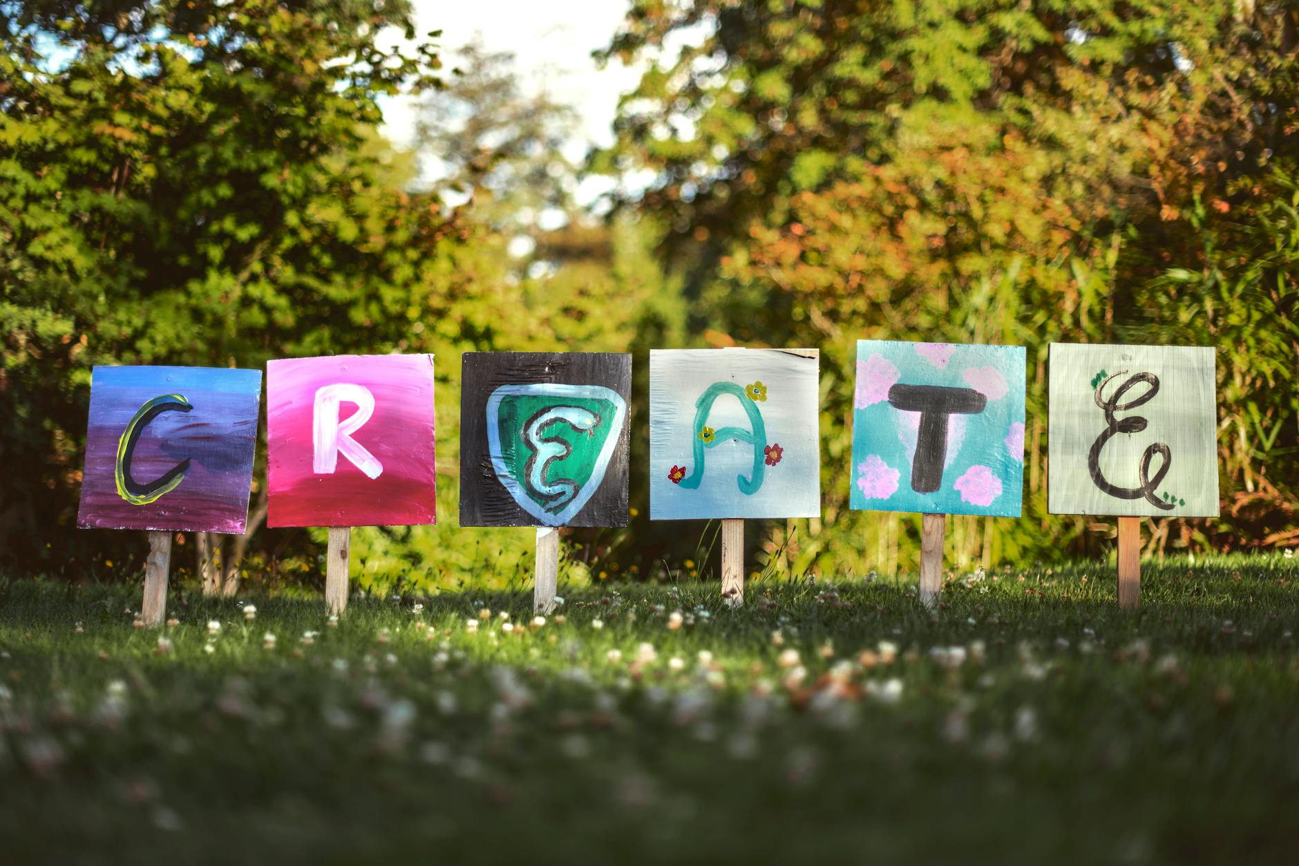 Art, Text To Image, Image, Create Art From Text, Artwork, Text To Art, Pict — Vibrant painted signs spelling CREATE in a lush outdoor g