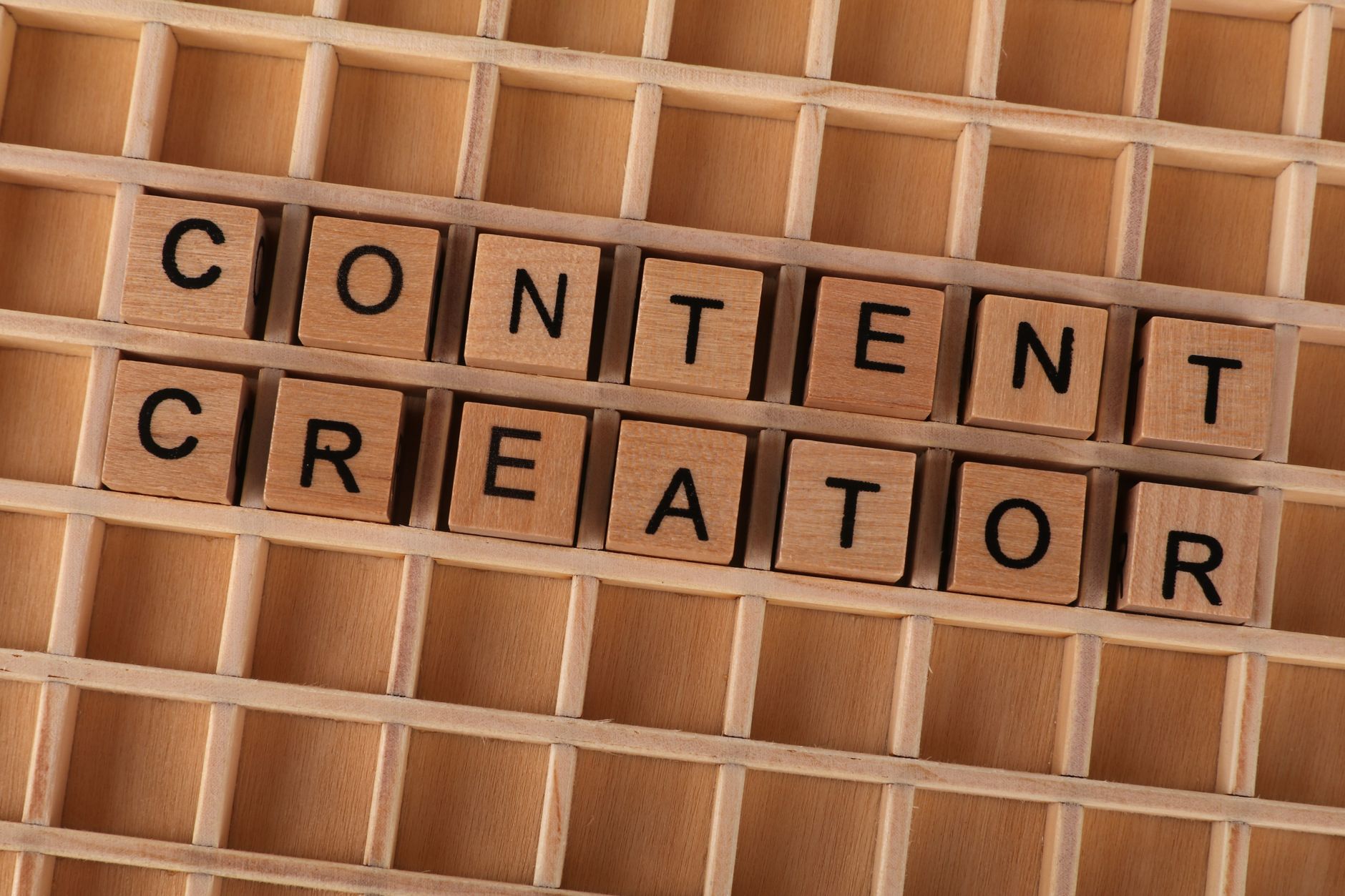 Content, Script, Caption, Hook, Content Idea on a grid with wooden letter blocks spelling Content Creator