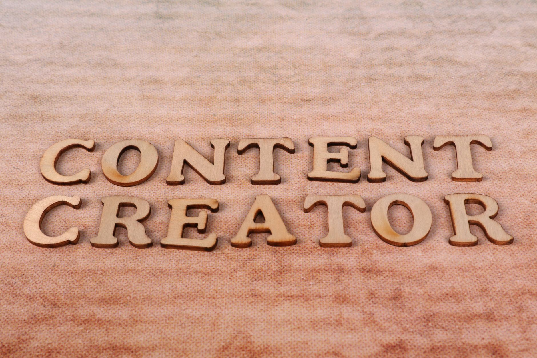 Content, Script, Caption, Hook, Content Idea, Writing For Creators, Social — Wooden letters spelling Content Creator arranged on a tex