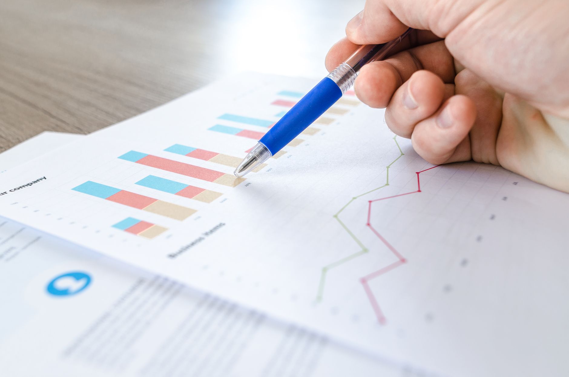 Data Analysis, Data Insights, Analyze Data With, Data Visualization, Automate — A close-up of a hand with a pen analyzing data on colorfu