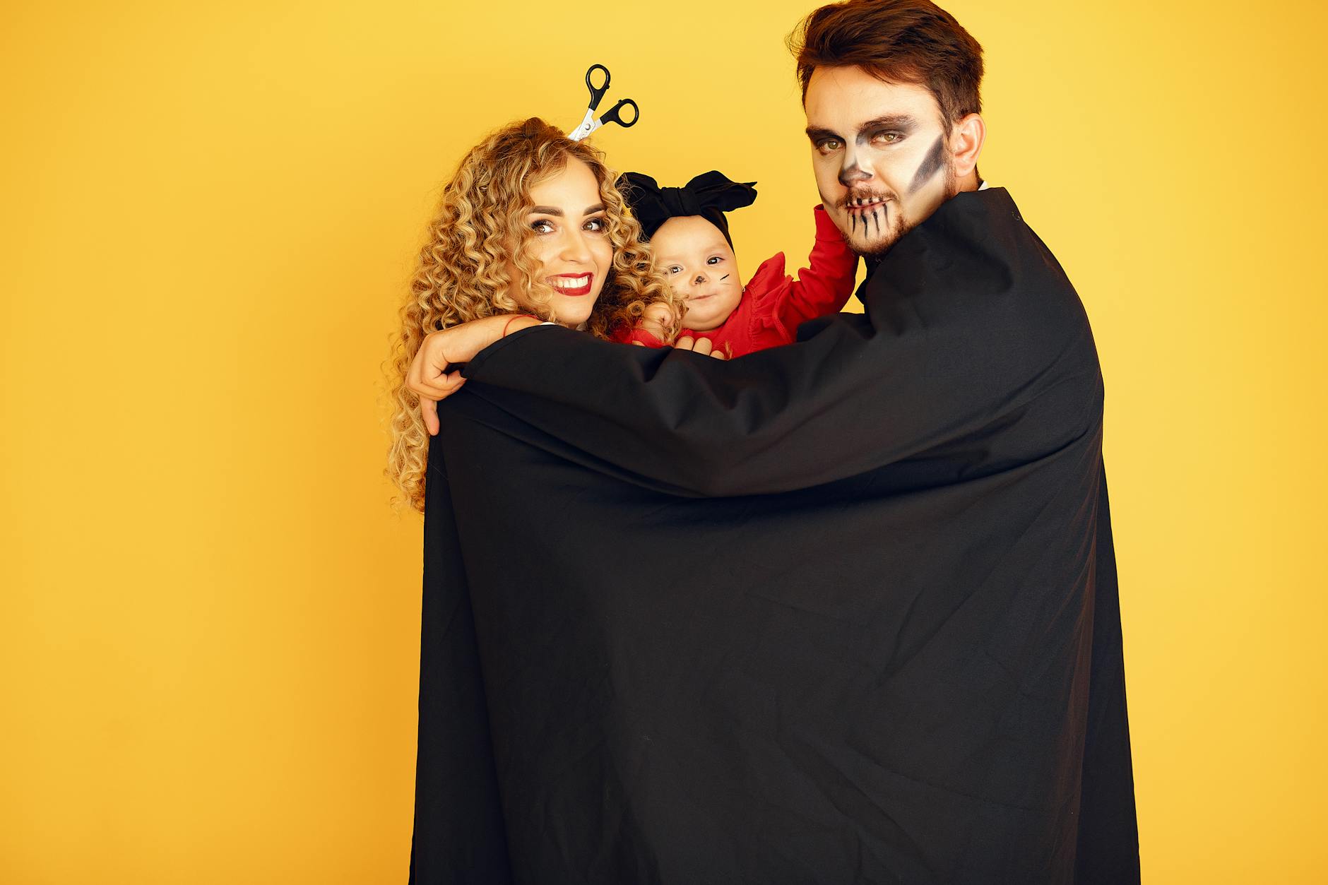Face Swap — Family in Halloween costumes with face art against a yellow background.