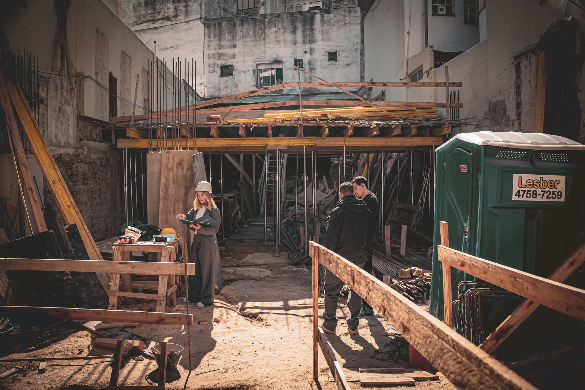 For Construction, Construction Assistant, For Building, For Contractors — Construction site with workers and architect reviewing plans in br