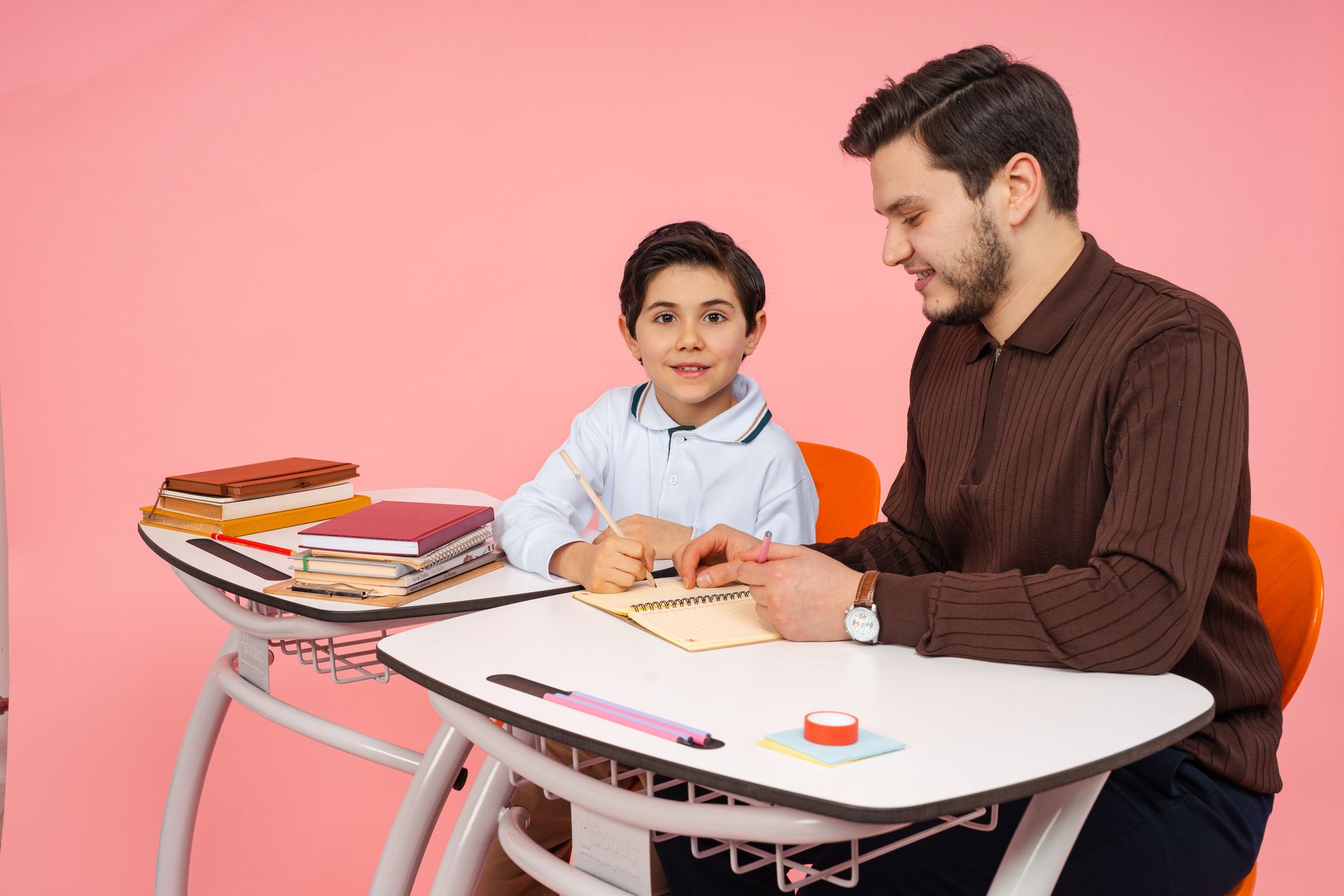 For Education, -Powered Learning Tools, Study Assistant, Learn Smarter With, Tu — A father assists his young son with homework at a desk in