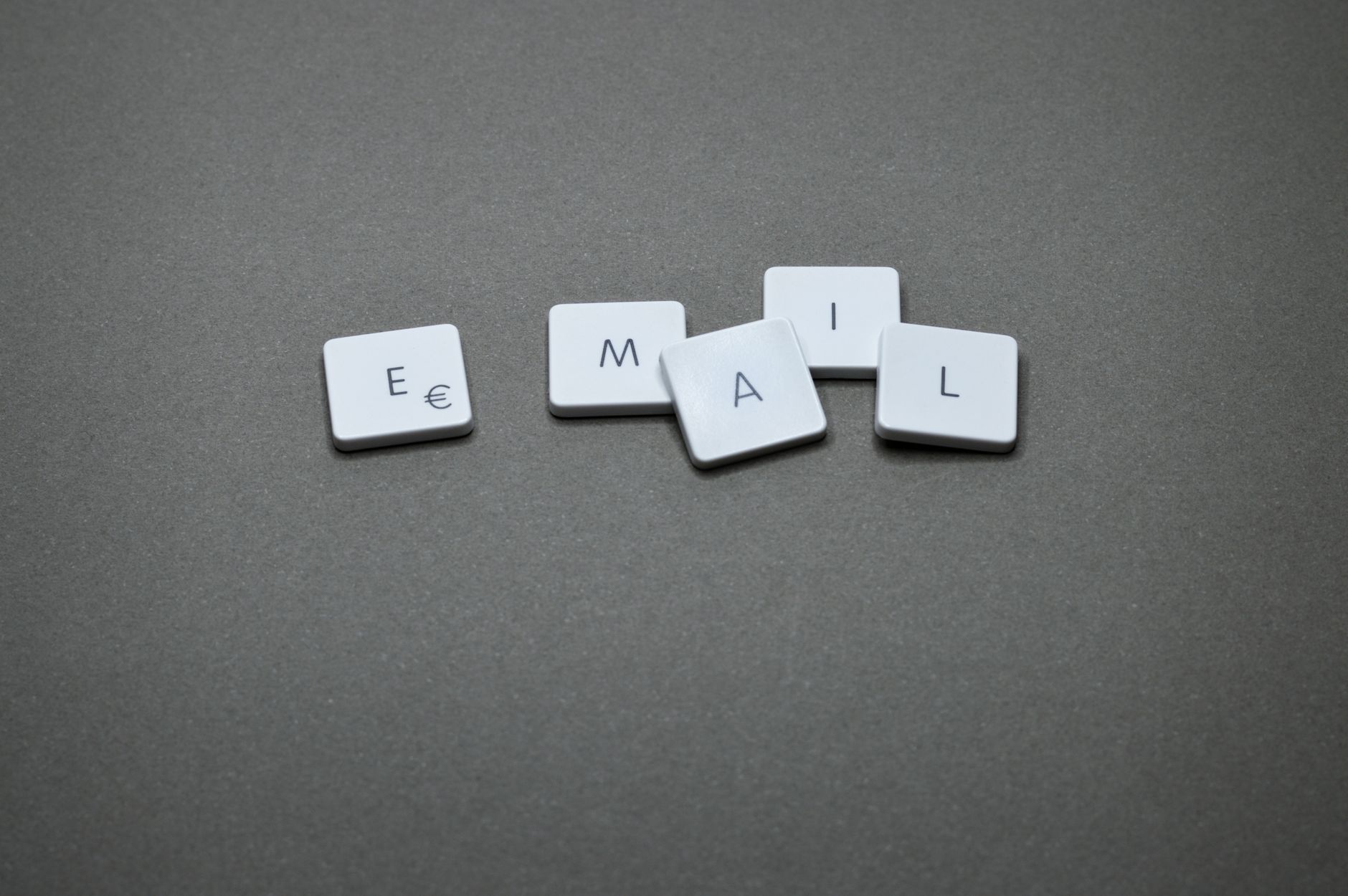 For Email, Email Writer, Email, For Email Management, For Email Writing — Close-up of the word email formed with letter tiles on a gray sur