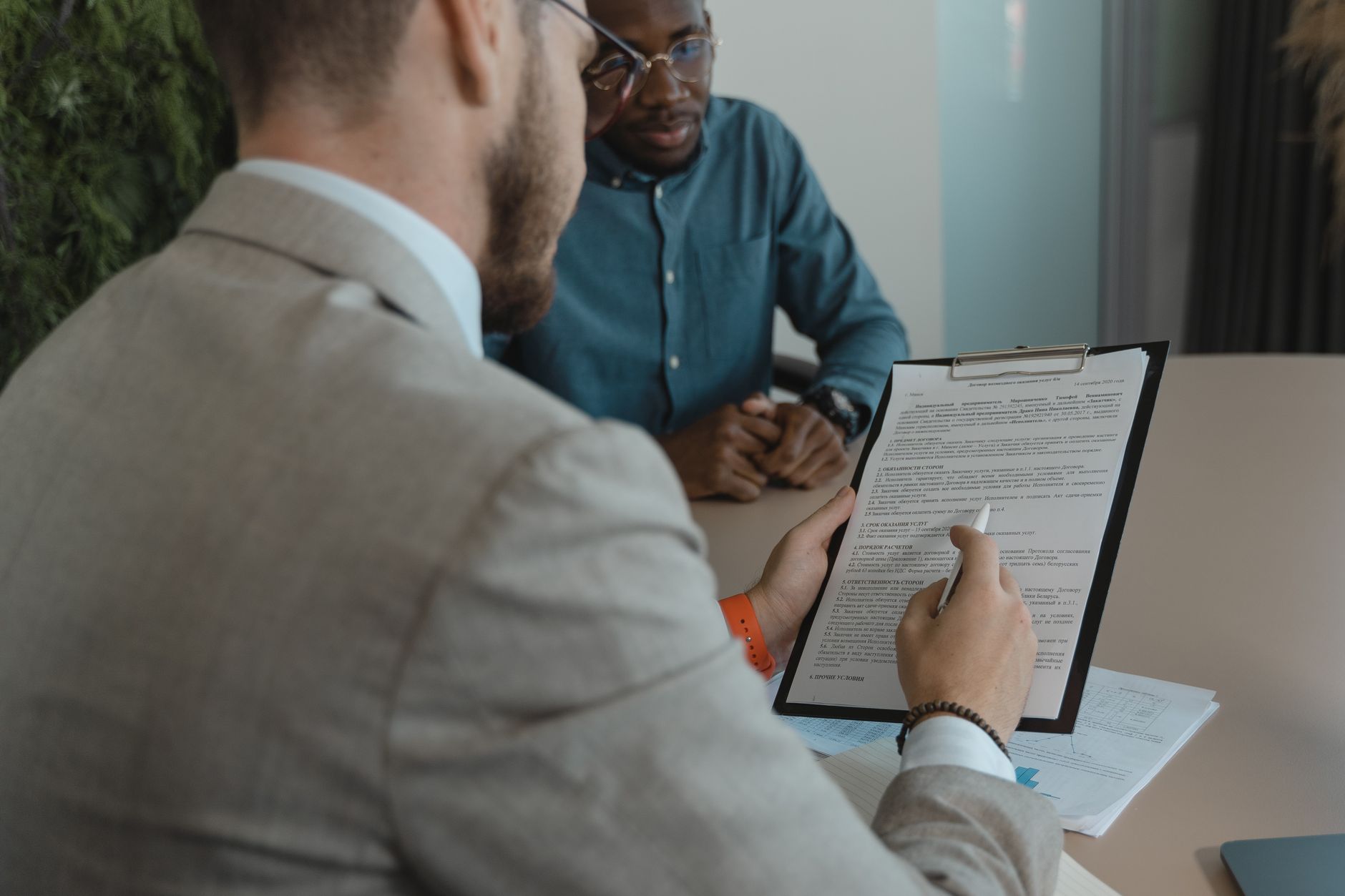 For Hr, For Human Resources, For Recruiting, For Hiring — A recruiter reviews a candidate s documents during a job interview in a modern off