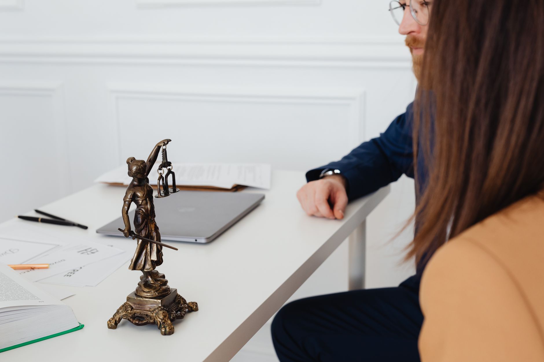 For Lawyers, Legal Assistant, For Law Firms — Professional setting with lawyers and Lady Justice statue discussing legal documents.