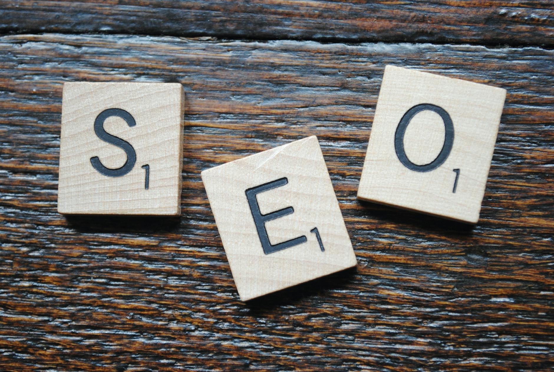 For Seo, Seo Writer, Seo Content, For Seo Writing, Seo — Close-up of Scrabble tiles spelling SEO on a wooden table for content strategy.