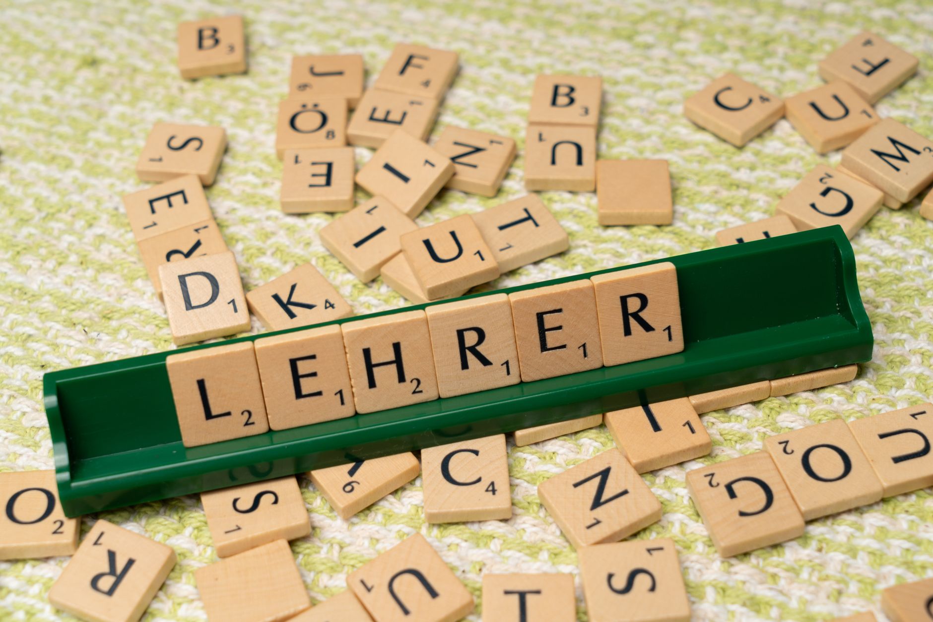 For Teachers, Lesson Plan, Quiz For Teachers, Classroom Resources, Create Lesso — Wooden letter tiles spelling Lehrer on a green rack, surr
