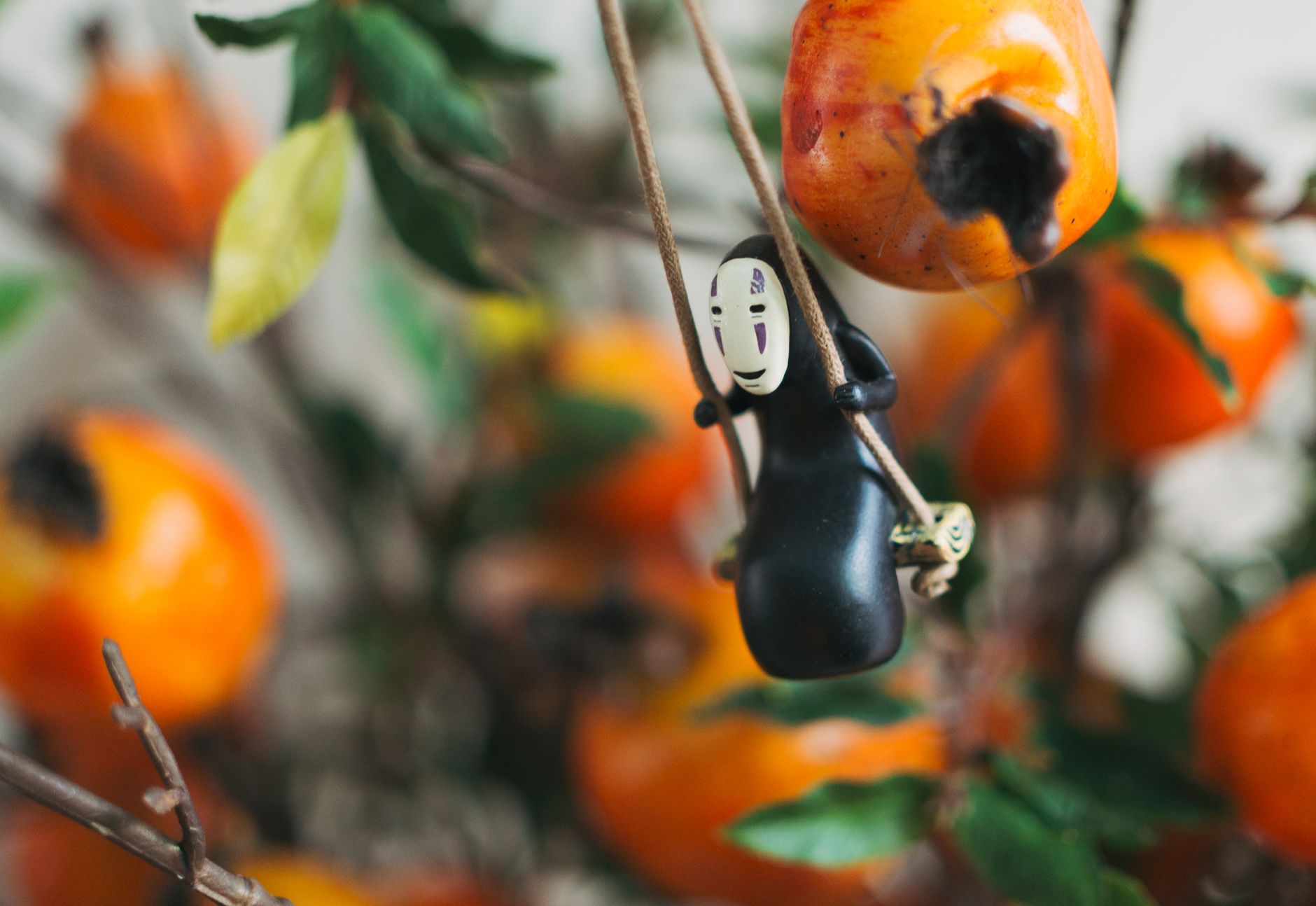 Ghibli Art,Ghibli Style Art,Studio Ghibli,Ghibli Art, Anime Art Ghibli,Ghibli — A charming figurine swings among ripe persimmons, creatin