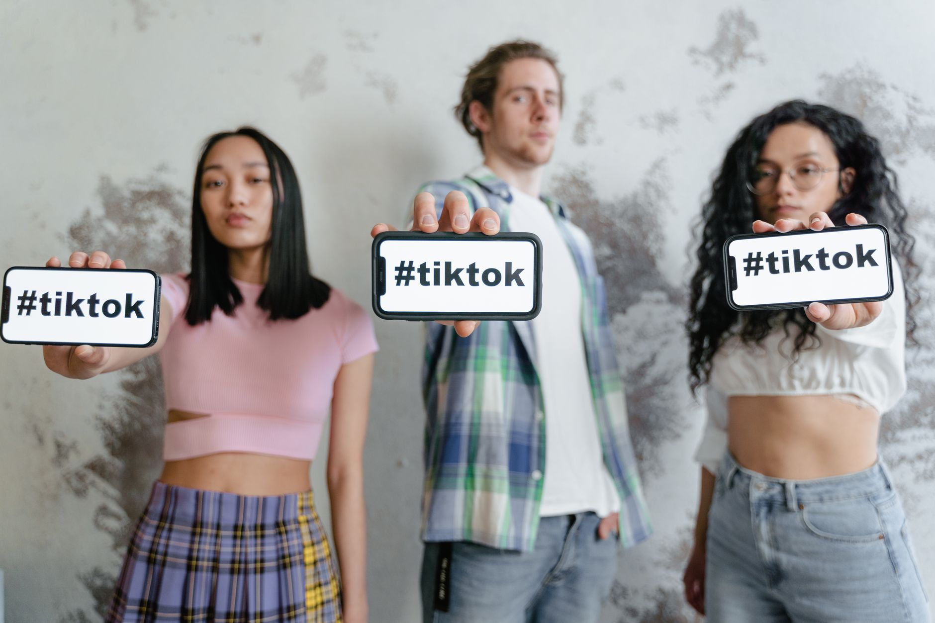 Group holding phones displaying hashtags theme