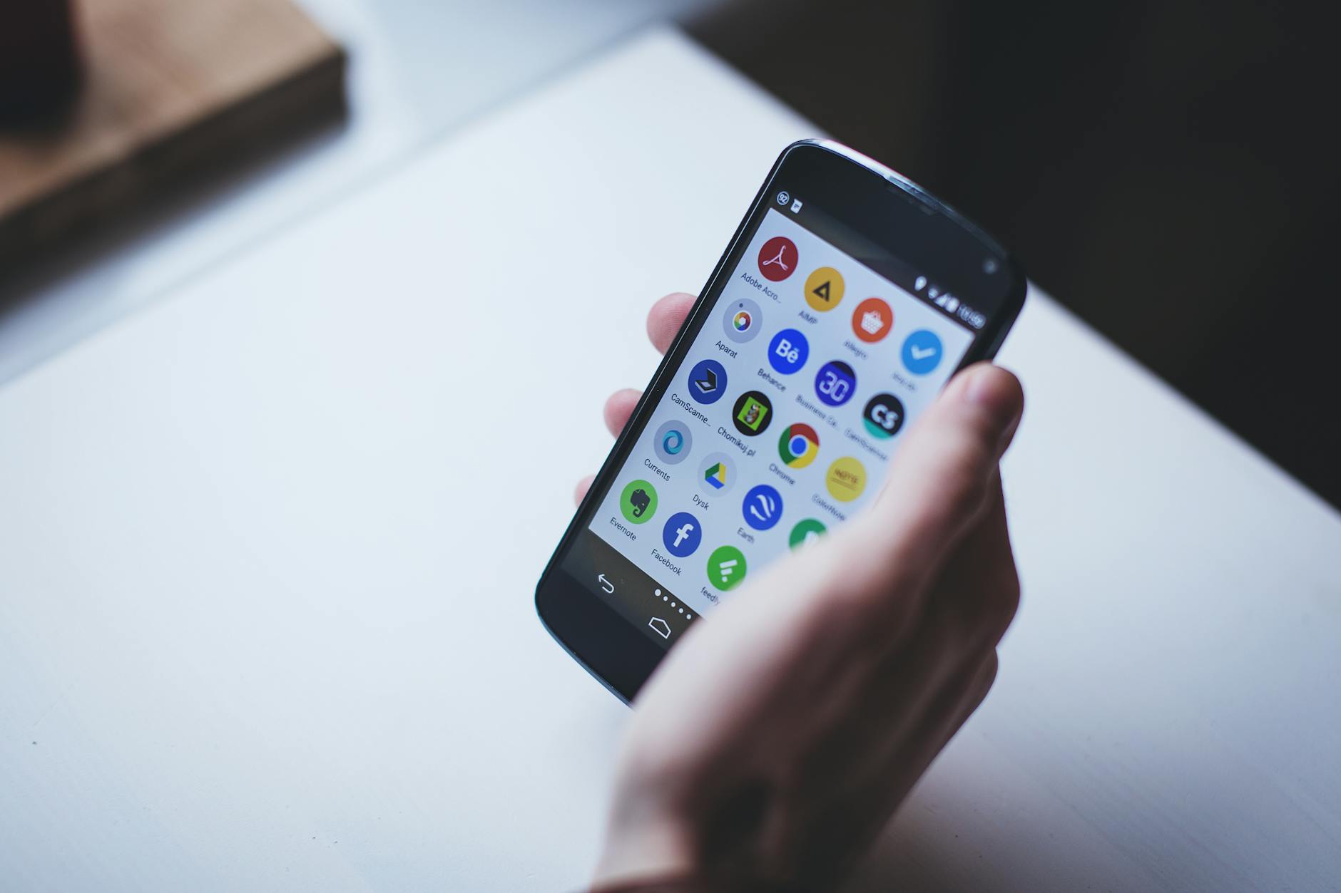 Mobile App Builder, React Native, Rork Alternative, Expo App Builder, App, Mob — Close-up of a person holding a smartphone with various ap