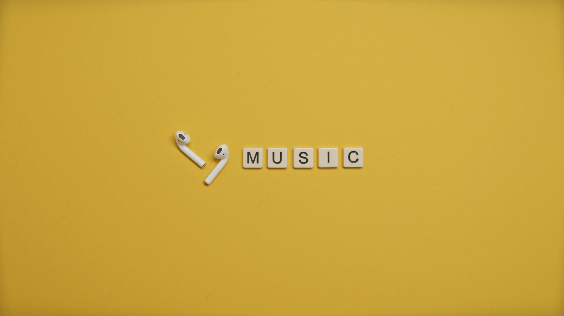 Music, Music, Jingle, Text To Music, Background Music — Minimalist image of AirPods and music-themed letter tiles on a vibrant yellow ba