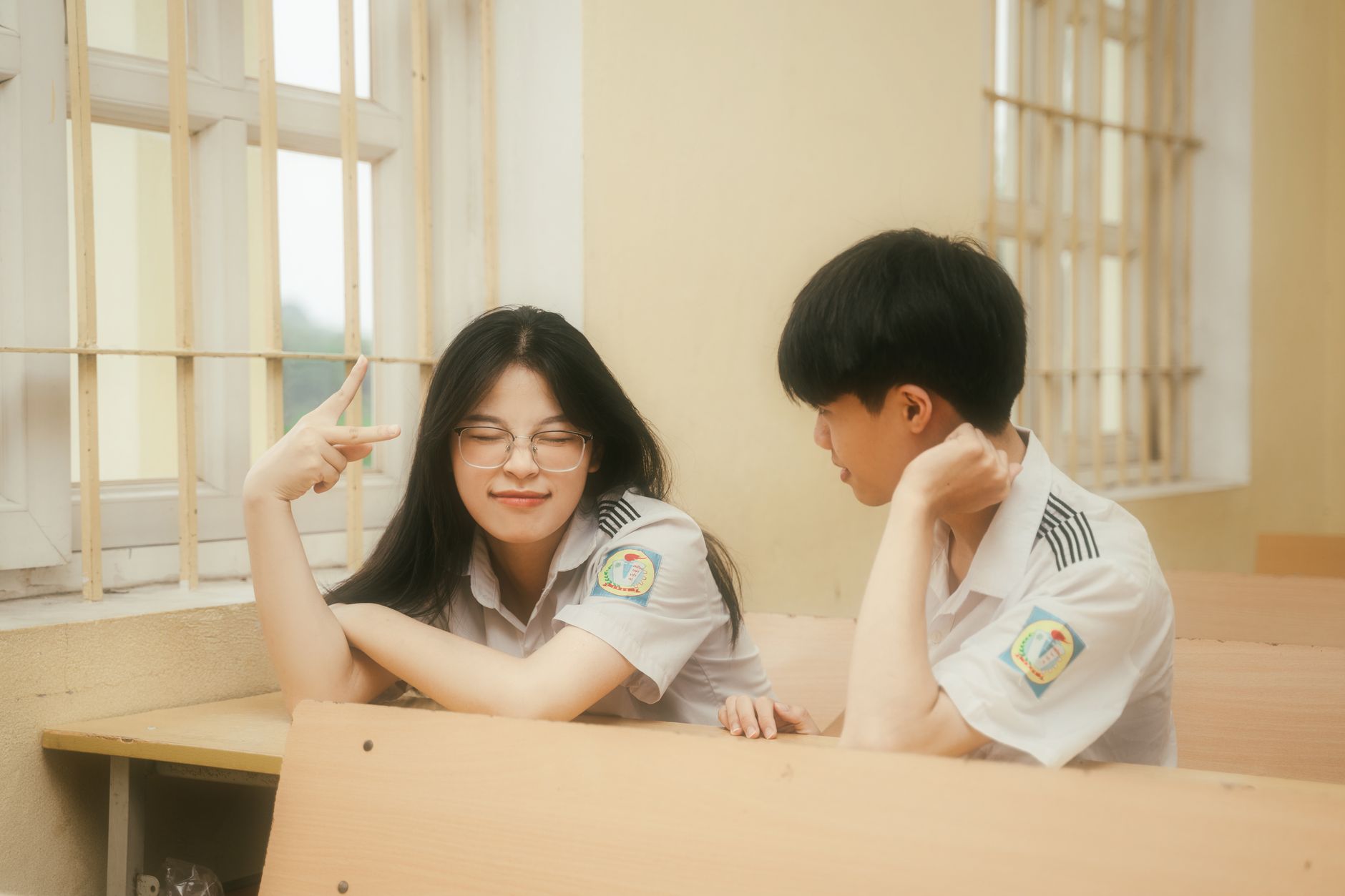 Pickup Line, Funny Pickup Lines, Smooth Pickup Lines, Pickup Line — Two Asian students in school uniforms sitting at a desk, smiling and t