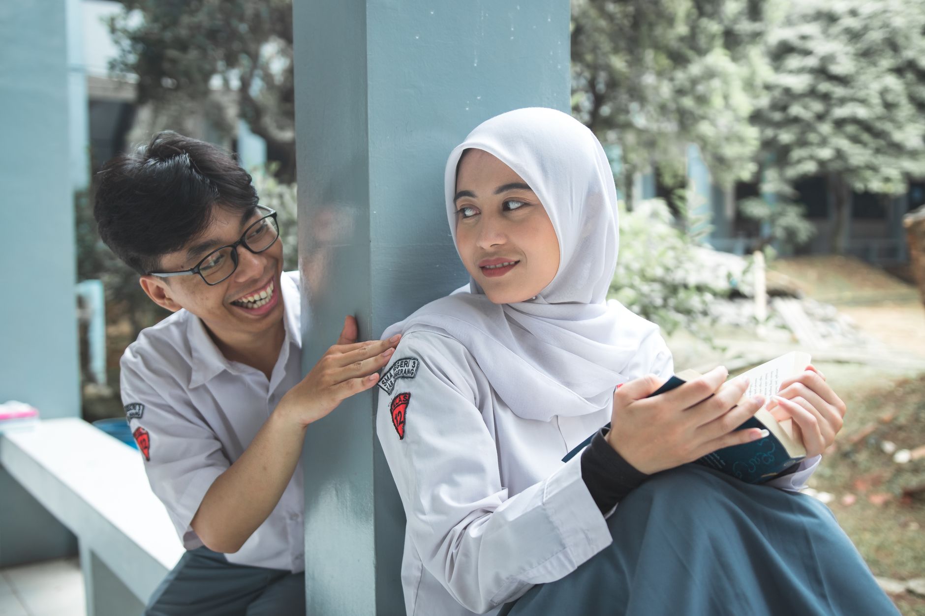 Pickup Line, Funny Pickup Lines, Smooth Pickup Lines, Pickup Line — Two students sharing a light moment while studying outdoors, dressed i