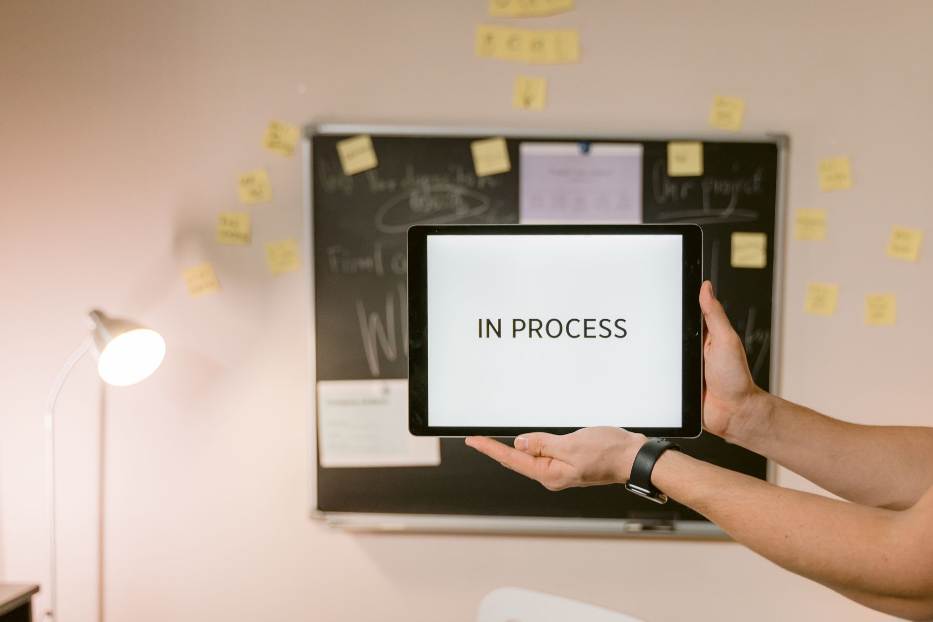 Product Manager, PRD, Product Roadmap Builder, Generate User Stories With, Pr — Tablet with In Process text held in an office setting, un