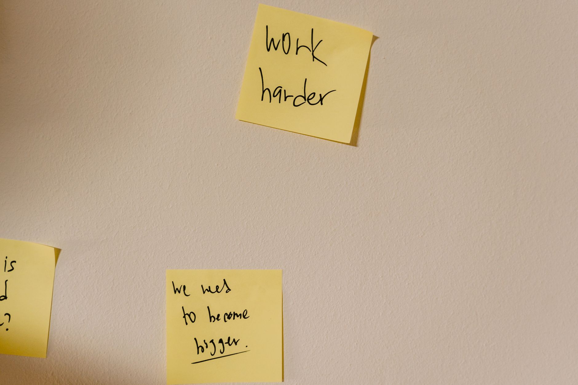 Prompt — Yellow sticky notes with motivational phrases posted on a white wall, inspiring action.
