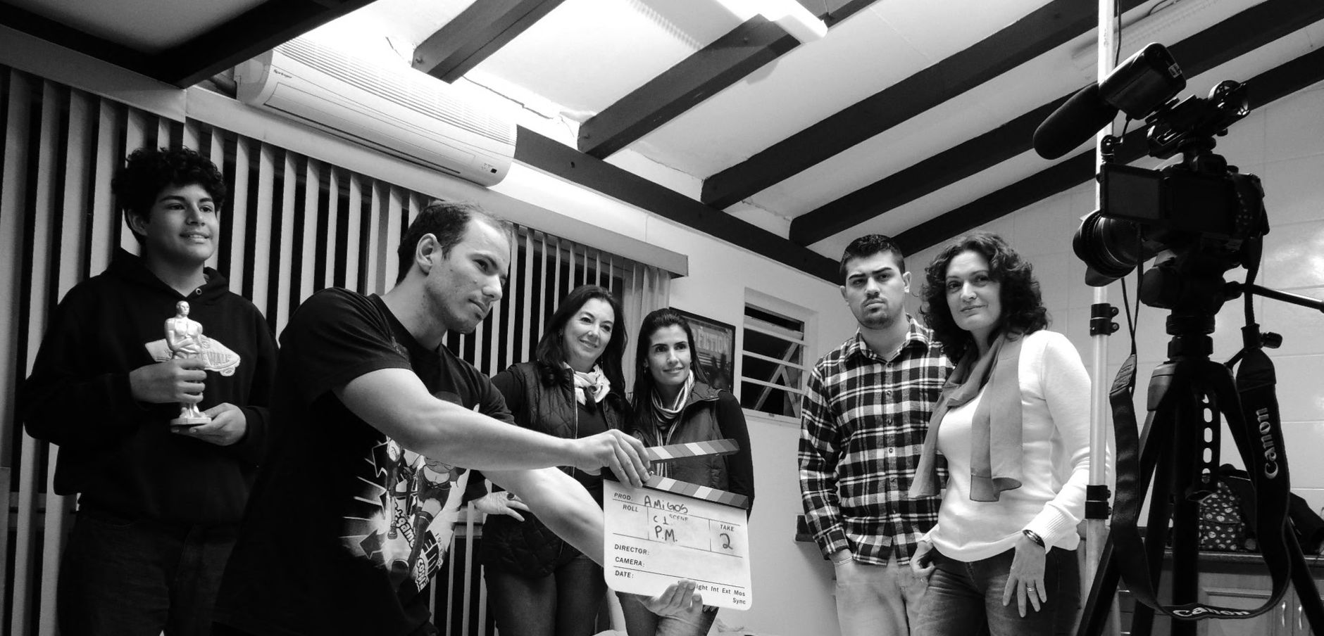 Subtitle, Auto Captions, Video To Srt, Captions, Subtitle — A group of adults collaborate on a filmmaking project, seen holding a clapperb