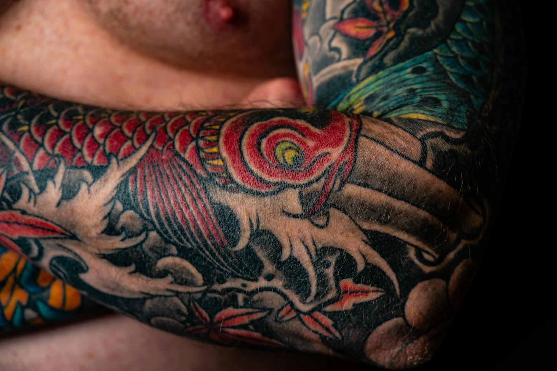 Tattoo — Close-up of a colorful Japanese style tattoo on a man s arm, featuring dragons and vibrant colors.
