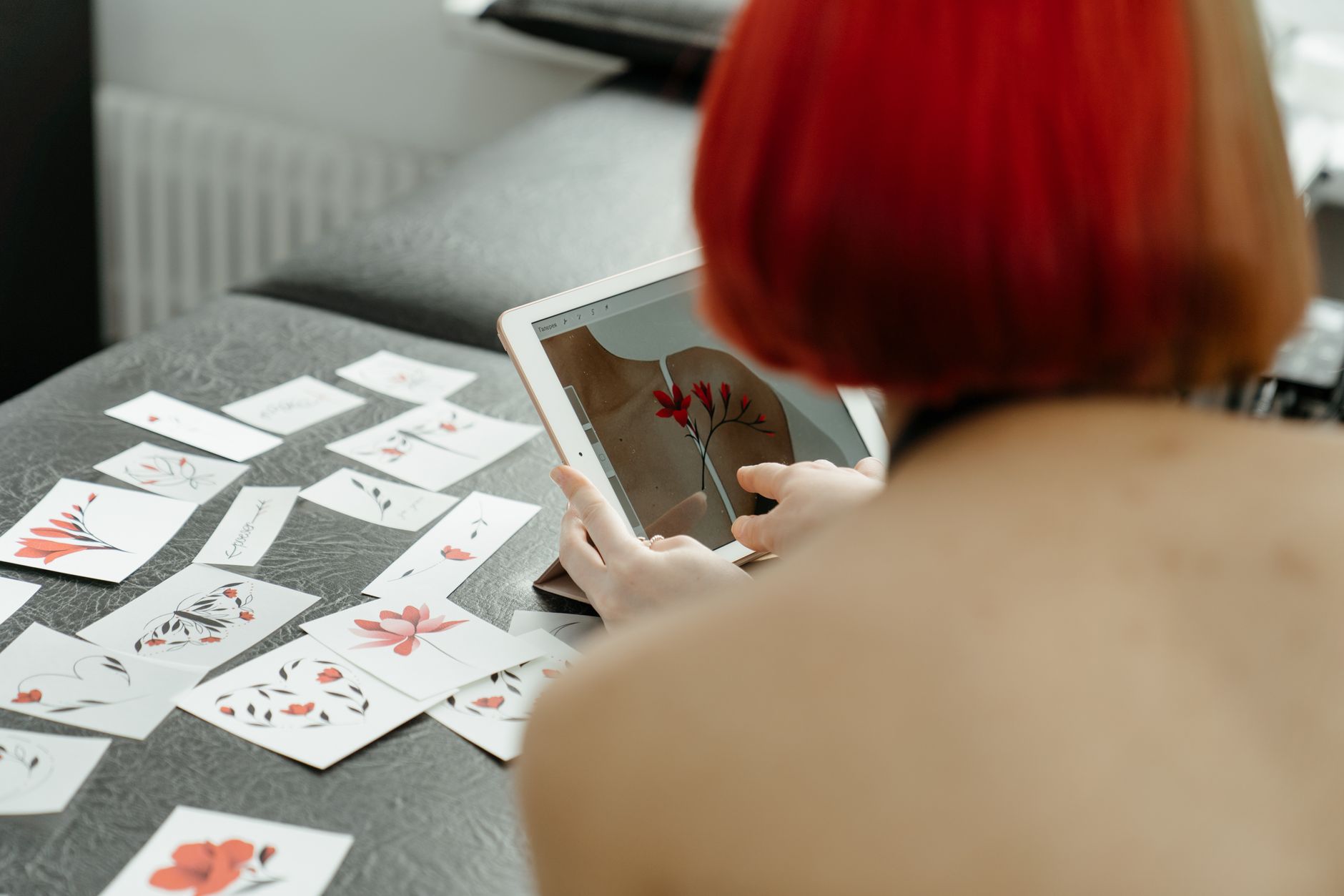 Tattoo, Tattoo Design, Tattoo, Free Tattoo, Custom Tattoo Design, Tattoo Id — A woman with red hair is using a tablet to create floral 