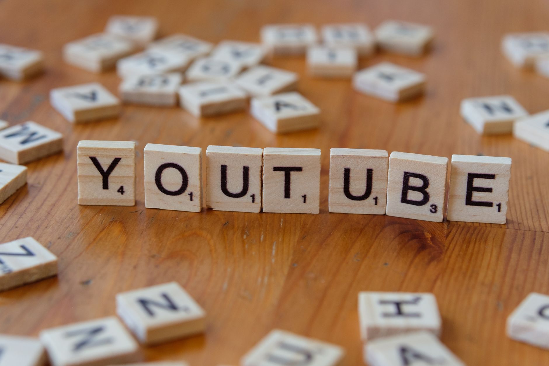 Video Creation, Video, Video Creation, Create Video With, Video, Text To Vi — Wooden letter tiles spelling YOUTUBE on a wooden surface,