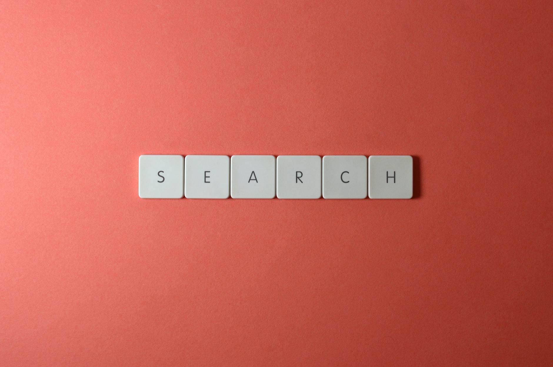 Video Title, Youtube Title, Clickbait Title, Video Title Ideas — White keyboard keys spelling search on a bold red surface, conceptual de