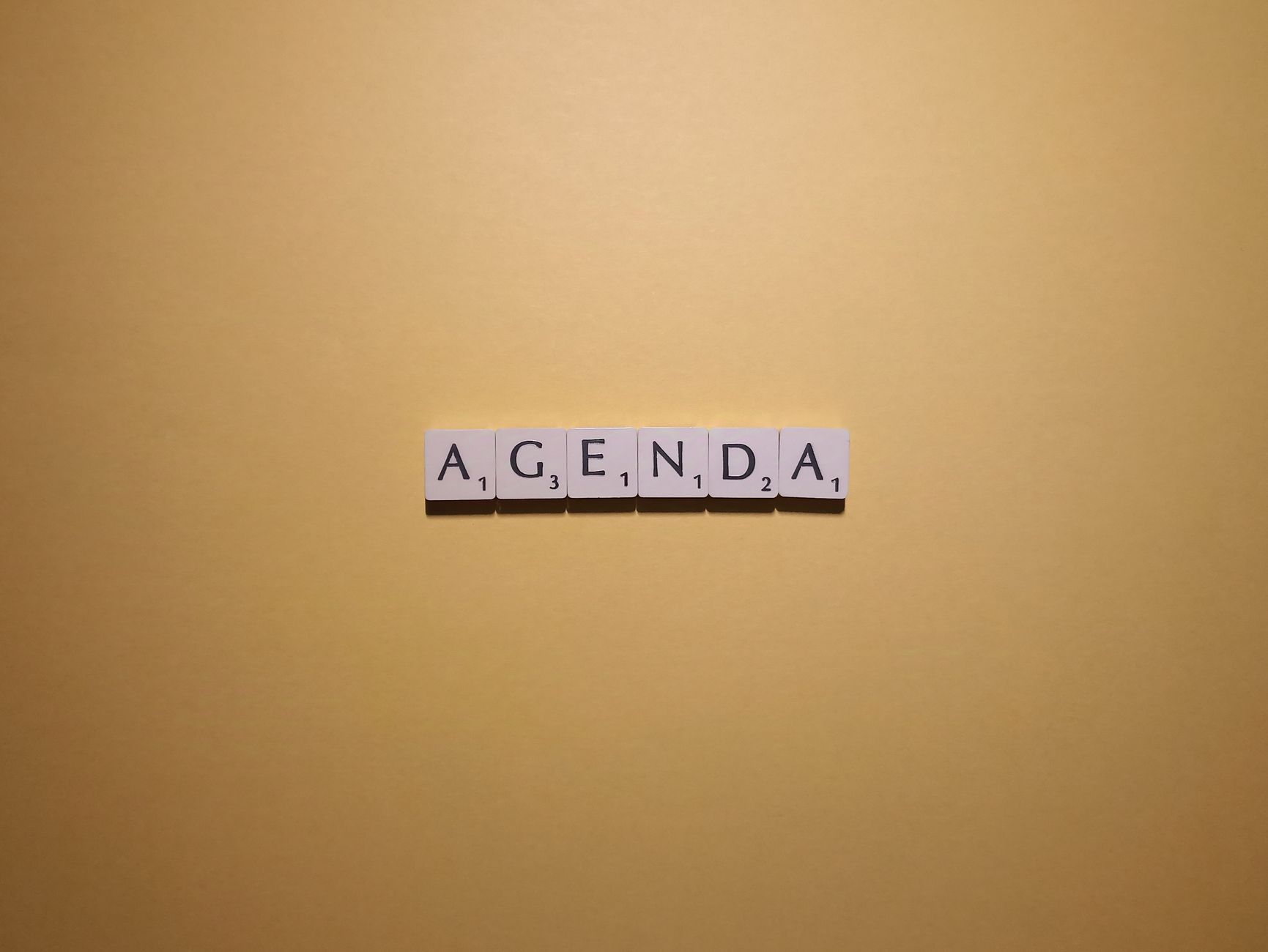 Video Title, Youtube Title, Clickbait Title, Video Title Ideas — Scrabble tiles spelling Agenda on a simple yellow background. Perfect fo