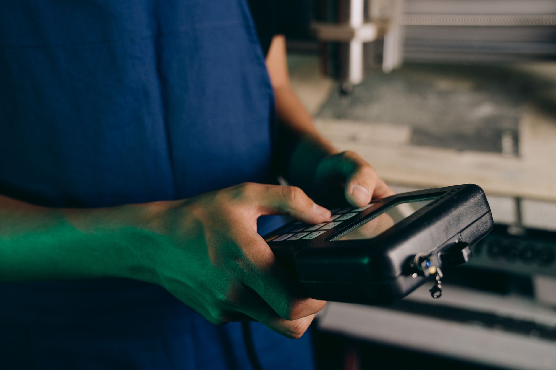 Workflow Automation, Automate Repetitive Tasks With, Process Automation Tools, — Close-up of technician using a handheld control device in