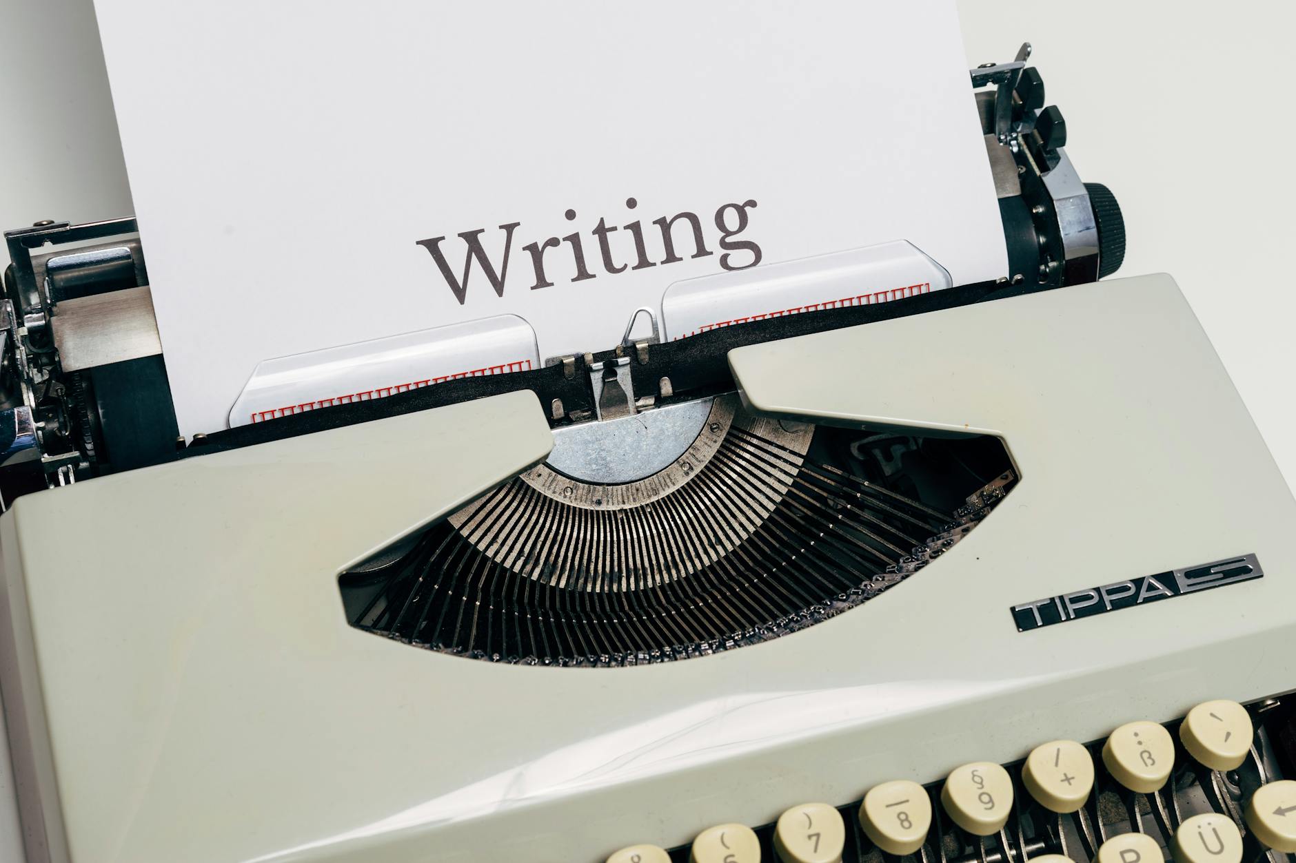 Writing Assistant, Content, Write Faster With, Writing, Smart Writing, Parag — Classic vintage typewriter displaying the word Writing on