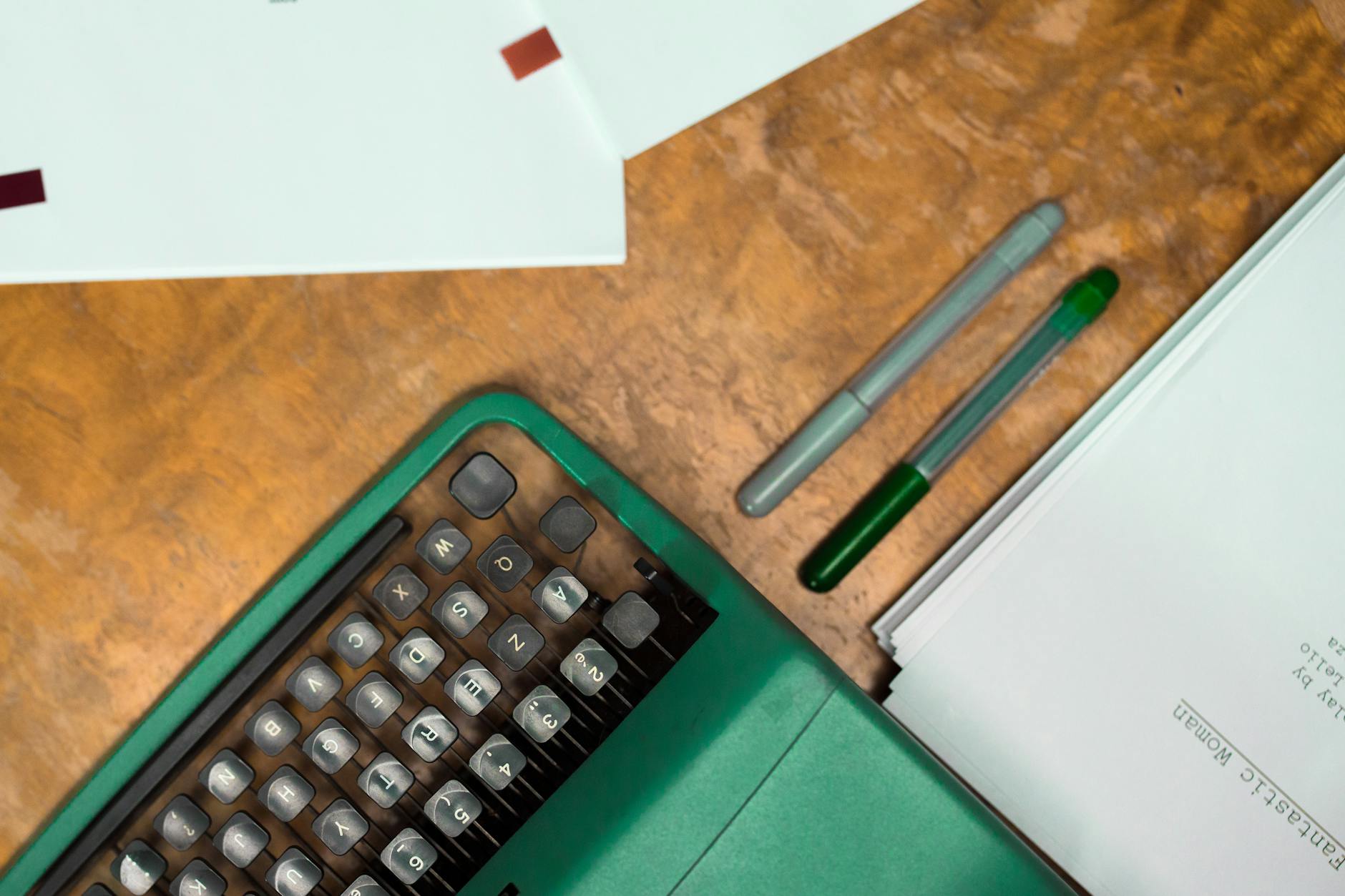Writing Assistant, Content, Write Faster With, Writing, Smart Writing, Parag — Flat lay of a green vintage typewriter, papers, and pens 