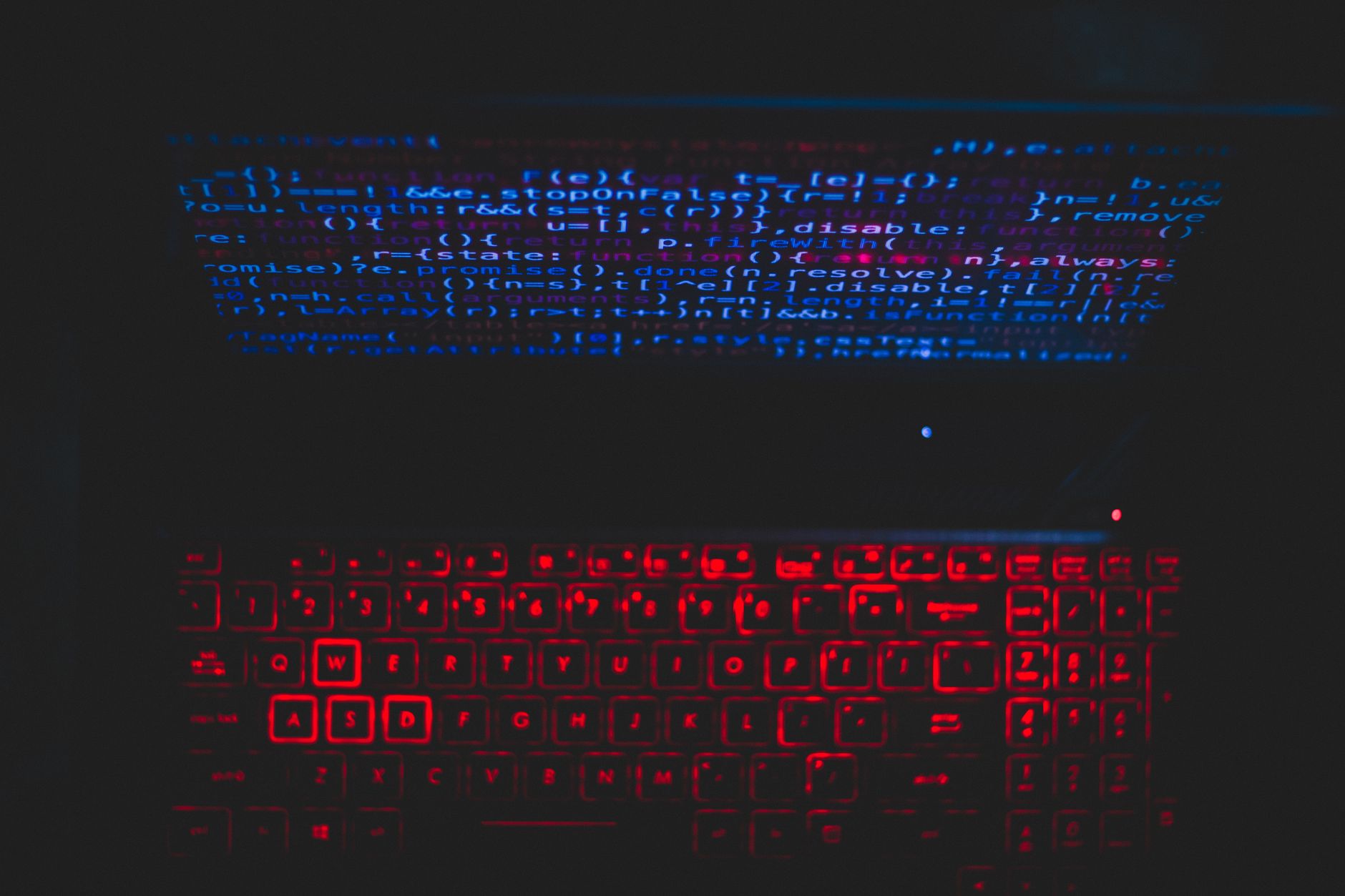 Best For Coding — Dark-themed laptop setup with a red glowing keyboard and code on screen, ideal for tech enthusiasts.
