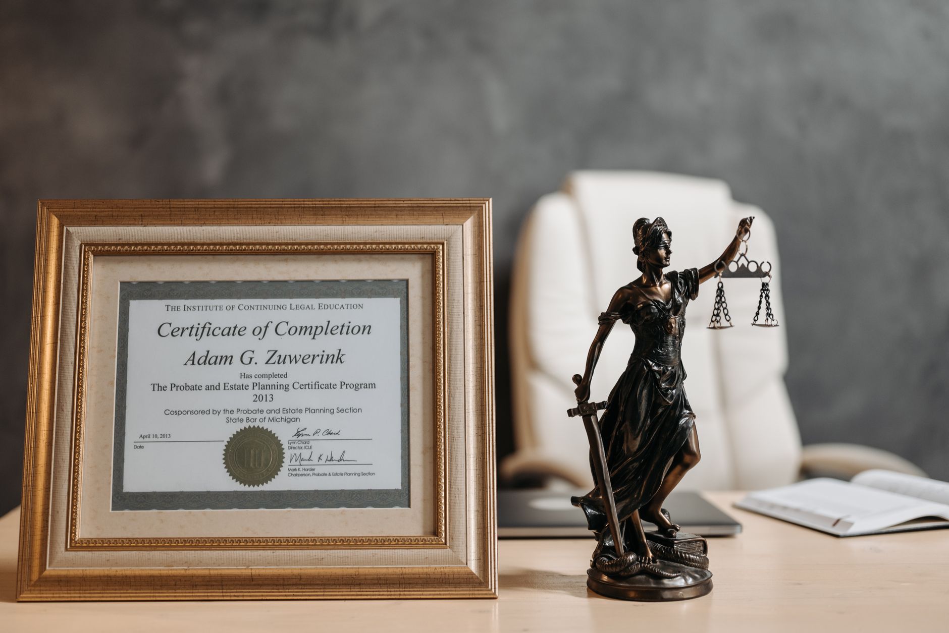 Best For Lawyers — A framed legal certificate and Lady Justice figurine on a desk in a law office setting.
