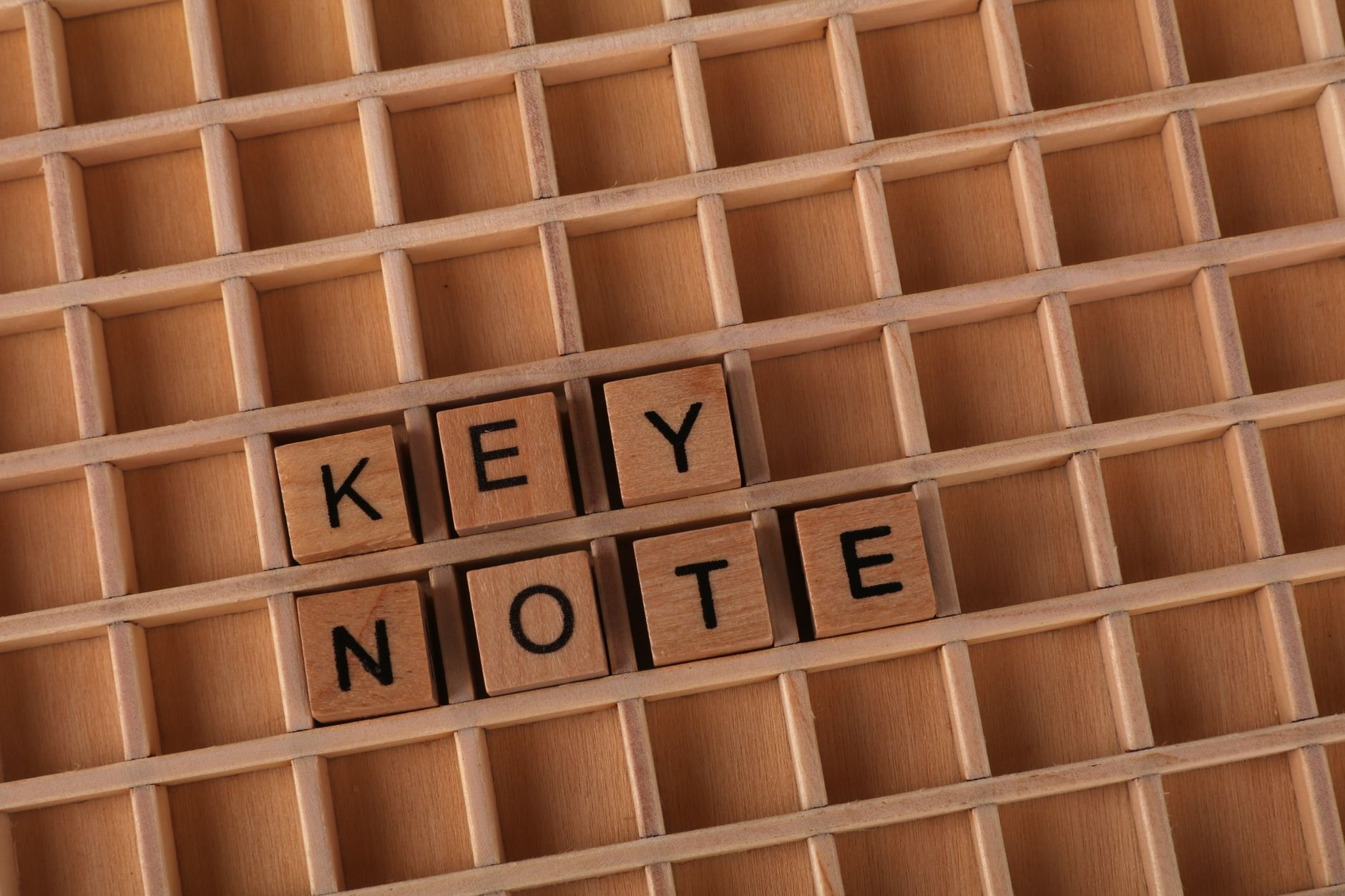 Best For Speech Writing — Top view of wooden letter tiles spelling Keynote on a wooden grid background.