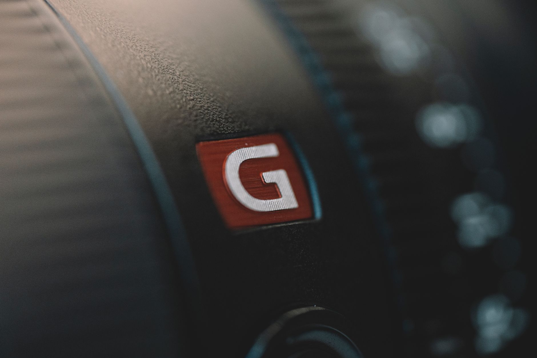 Best Image For Logo — Macro shot of a camera lens showing a prominent G logo on its surface.