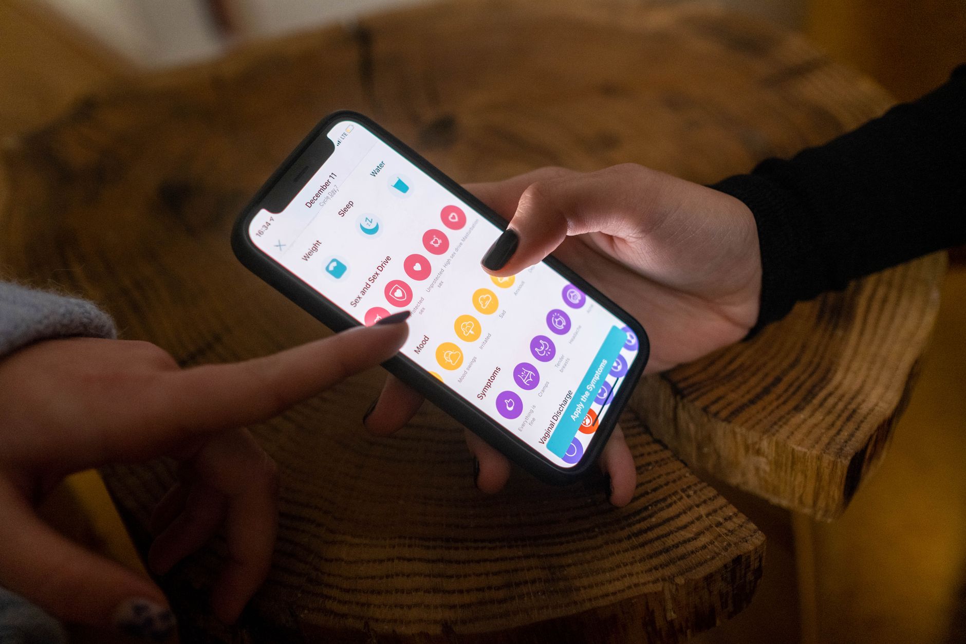 Habit Tracker App, Best Habit Tracker, Habit Tracker, Daily Habit Tracker, Habit — Close-up of hands using a fertility tracking app on a sma